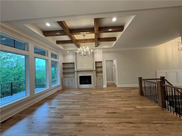 22428 W 90th Ter, Lenexa, KS 66227 - unfurnished living room with a chandelier, beamed ceiling, light wood-style floors, coffered ceiling, and recessed lighting