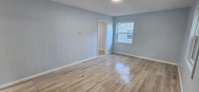 2918 S 52nd Ter, Kansas City, KS 66106 - empty room with light wood finished floors, baseboards, and wood walls