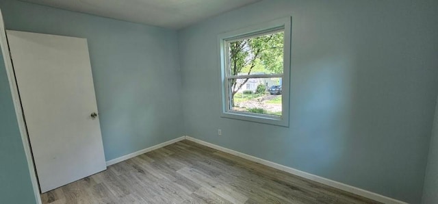 2918 S 52nd Ter, Kansas City, KS 66106 - unfurnished room featuring healthy amount of natural light, baseboards, and wood finished floors
