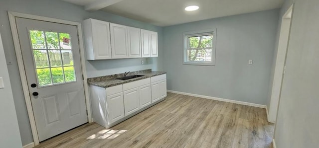 2918 S 52nd Ter, Kansas City, KS 66106 - kitchen with a sink, light wood-style flooring, white cabinetry, baseboards, and recessed lighting