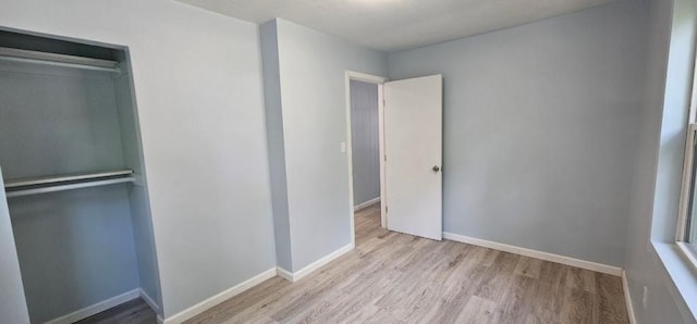 2918 S 52nd Ter, Kansas City, KS 66106 - unfurnished bedroom with wood finished floors, baseboards, and a closet