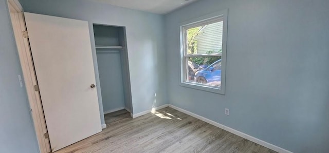 2918 S 52nd Ter, Kansas City, KS 66106 - unfurnished bedroom featuring light wood-type flooring, a closet, and baseboards