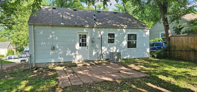 2918 S 52nd Ter, Kansas City, KS 66106 - back of property with a patio area, cooling unit, and roof with shingles