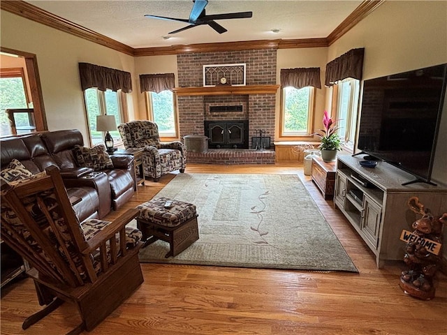 2819 S Dillingham Rd, Grain Valley, MO 64029 - living area featuring plenty of natural light, a ceiling fan, ornamental molding, a fireplace, and a textured ceiling
