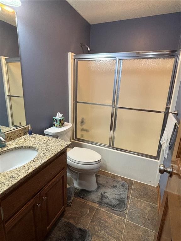 2819 S Dillingham Rd, Grain Valley, MO 64029 - bathroom featuring vanity, enclosed tub / shower combo, toilet, and stone finish floors