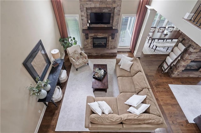 24901 W 91st Pl, Lenexa, KS 66227 - living area with wood finished floors, a stone fireplace, and baseboards