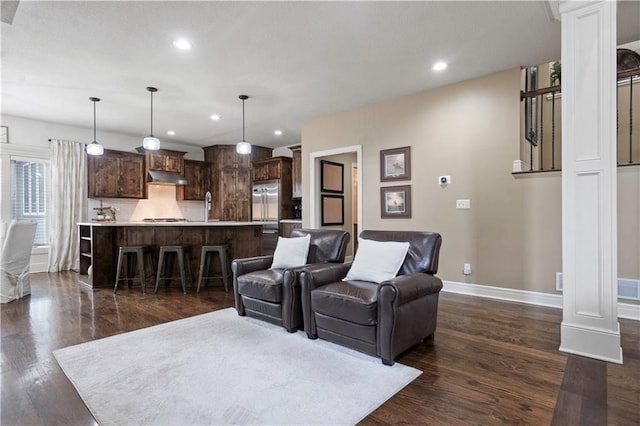 24901 W 91st Pl, Lenexa, KS 66227 - living room with dark wood finished floors, baseboards, recessed lighting, and ornate columns