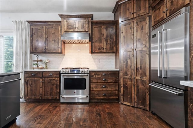24901 W 91st Pl, Lenexa, KS 66227 - kitchen featuring appliances with stainless steel finishes, exhaust hood, light countertops, and dark wood finished floors