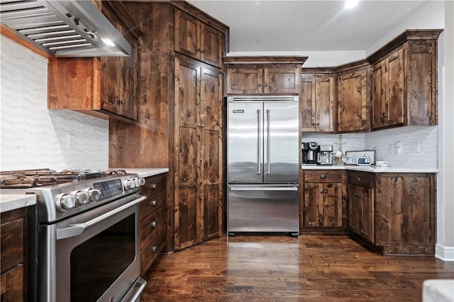 24901 W 91st Pl, Lenexa, KS 66227 - kitchen with stainless steel appliances, range hood, light countertops, and dark wood-type flooring