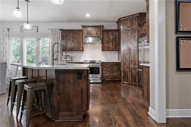 24901 W 91st Pl, Lenexa, KS 66227 - kitchen with stainless steel range with gas cooktop, dark wood-style floors, backsplash, baseboards, and under cabinet range hood