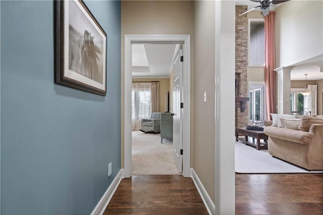 24901 W 91st Pl, Lenexa, KS 66227 - hall featuring dark wood finished floors, baseboards, and decorative columns