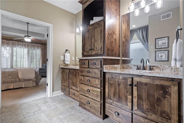 24901 W 91st Pl, Lenexa, KS 66227 - ensuite bathroom featuring healthy amount of natural light, vanity, stone tile floors, and ceiling fan