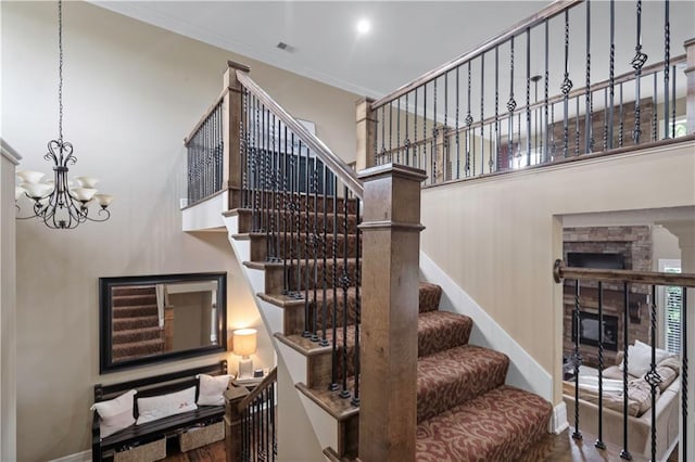 24901 W 91st Pl, Lenexa, KS 66227 - stairway featuring baseboards, a chandelier, crown molding, and wood finished floors