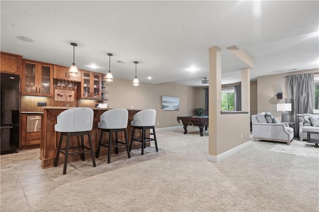 24901 W 91st Pl, Lenexa, KS 66227 - kitchen with freestanding refrigerator, open floor plan, billiards, brown cabinetry, and a kitchen breakfast bar