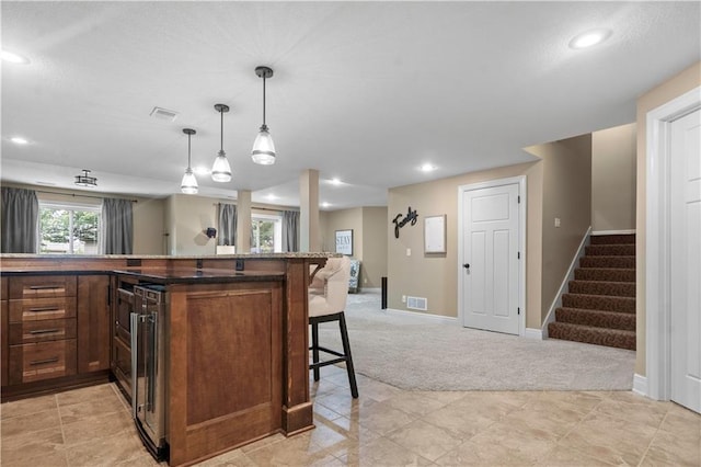 24901 W 91st Pl, Lenexa, KS 66227 - kitchen with light carpet, a breakfast bar area, baseboards, open floor plan, and pendant lighting