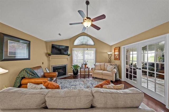 2051 W 139th Ter, Leawood, KS 66224 - living room featuring dark wood-style flooring, vaulted ceiling, plenty of natural light, a fireplace with flush hearth, and ceiling fan