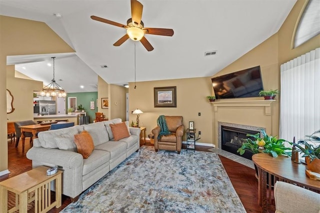 2051 W 139th Ter, Leawood, KS 66224 - living room featuring lofted ceiling, dark wood-type flooring, a fireplace with flush hearth, a ceiling fan, and a chandelier
