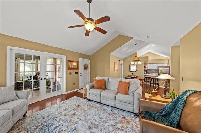 2051 W 139th Ter, Leawood, KS 66224 - living area with vaulted ceiling, a ceiling fan, french doors, and wood finished floors