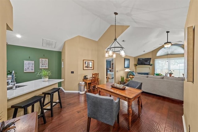 2051 W 139th Ter, Leawood, KS 66224 - dining room with lofted ceiling, dark wood-style flooring, ceiling fan, a fireplace, and recessed lighting
