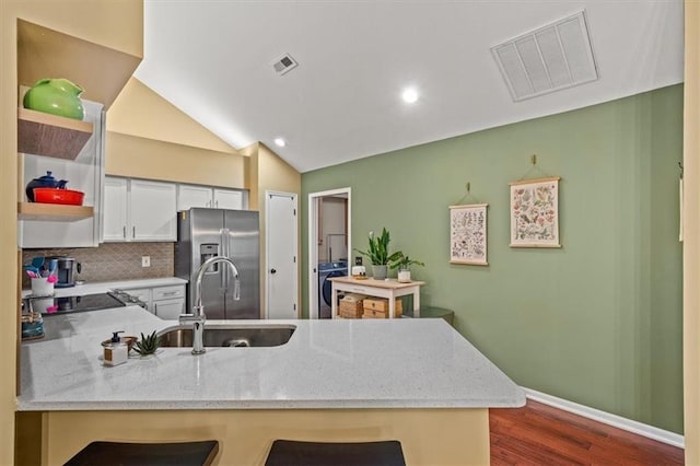 2051 W 139th Ter, Leawood, KS 66224 - kitchen with stainless steel fridge with ice dispenser, open shelves, a peninsula, washer / clothes dryer, and dark wood finished floors