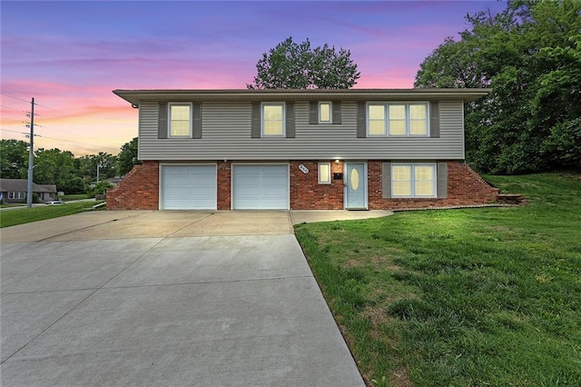 210 Murray Rd, Lees Summit, MO 64081 - view of front facade with driveway, brick siding, a front lawn, and a garage