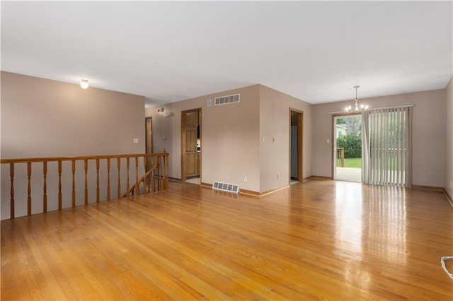 210 Murray Rd, Lees Summit, MO 64081 - empty room featuring a chandelier, light wood finished floors, and baseboards
