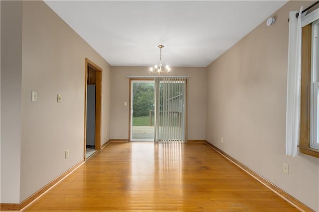 210 Murray Rd, Lees Summit, MO 64081 - unfurnished room featuring a chandelier, light wood-style flooring, baseboards, and a smoke detector