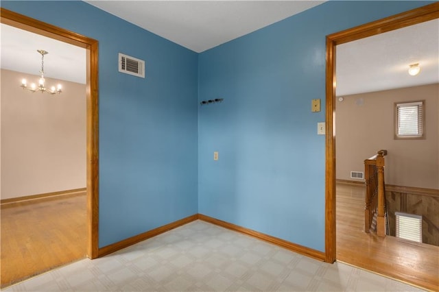 210 Murray Rd, Lees Summit, MO 64081 - spare room with a chandelier, tile patterned floors, and baseboards