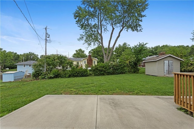 210 Murray Rd, Lees Summit, MO 64081 - view of green lawn featuring a patio and an outbuilding
