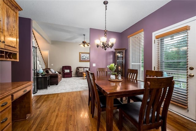 4422 N 122nd Ter, Kansas City, KS 66109 - dining area with a chandelier, dark wood-style floors, a ceiling fan, and stairway