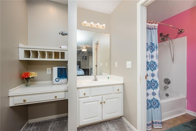 4422 N 122nd Ter, Kansas City, KS 66109 - bathroom featuring vanity, shower / tub combo with curtain, baseboards, and a textured ceiling