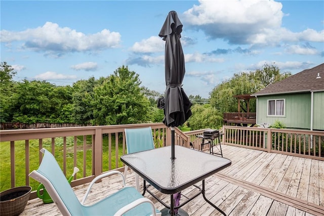 4422 N 122nd Ter, Kansas City, KS 66109 - wooden deck with outdoor dining area and a lawn