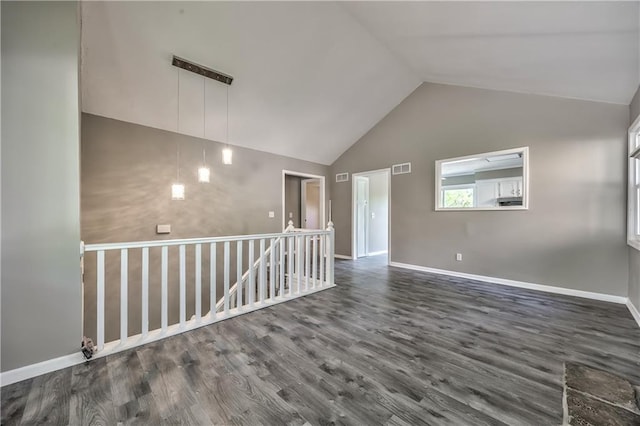 14033 Dornoch St, Grandview, MO 64030 - empty room with vaulted ceiling, wood finished floors, and baseboards