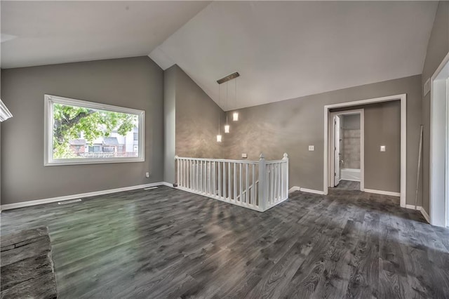 14033 Dornoch St, Grandview, MO 64030 - spare room with lofted ceiling, dark wood-style floors, and baseboards
