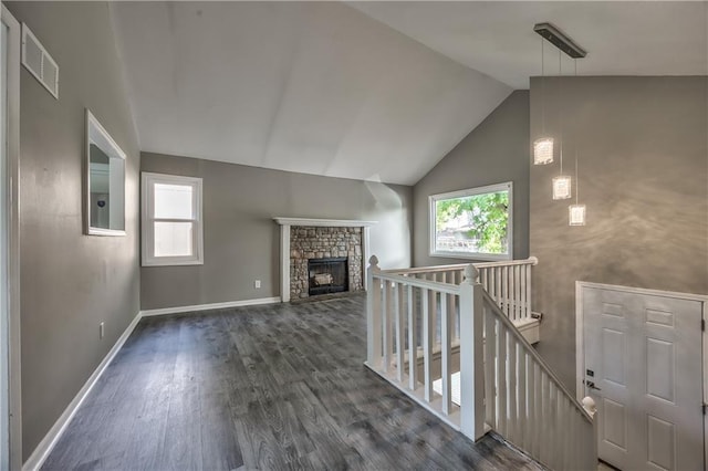 14033 Dornoch St, Grandview, MO 64030 - unfurnished living room featuring lofted ceiling, dark wood-style flooring, a fireplace, and baseboards