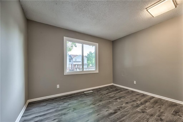 14033 Dornoch St, Grandview, MO 64030 - empty room with a textured ceiling, dark wood-style flooring, and baseboards
