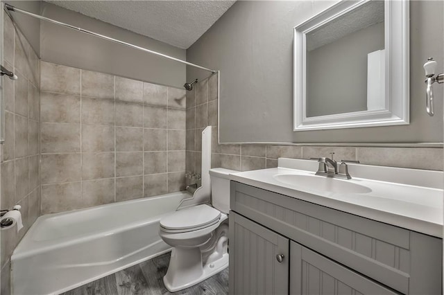 14033 Dornoch St, Grandview, MO 64030 - bathroom featuring a textured ceiling, shower / tub combination, vanity, wood finished floors, and toilet