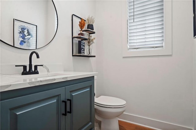 15318 W 172nd Pl, Olathe, KS 66062 - half bathroom with vanity, toilet, wood finished floors, and baseboards