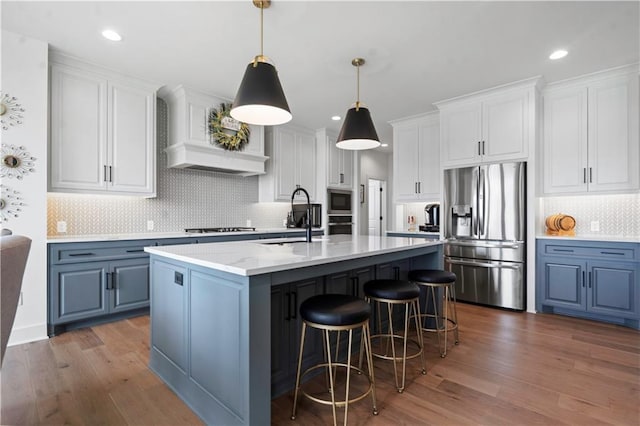 15318 W 172nd Pl, Olathe, KS 66062 - kitchen with stainless steel appliances, a sink, dark wood-style floors, white cabinetry, and recessed lighting