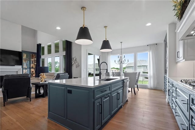 15318 W 172nd Pl, Olathe, KS 66062 - kitchen with a sink, stainless steel appliances, light countertops, an island with sink, and a chandelier