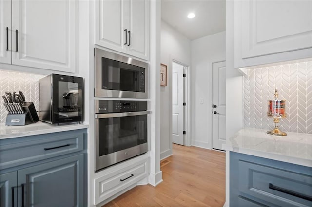 15318 W 172nd Pl, Olathe, KS 66062 - kitchen with appliances with stainless steel finishes, backsplash, white cabinets, and recessed lighting