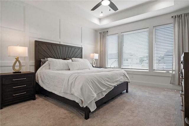 15318 W 172nd Pl, Olathe, KS 66062 - bedroom featuring a decorative wall, a raised ceiling, light carpet, and a ceiling fan