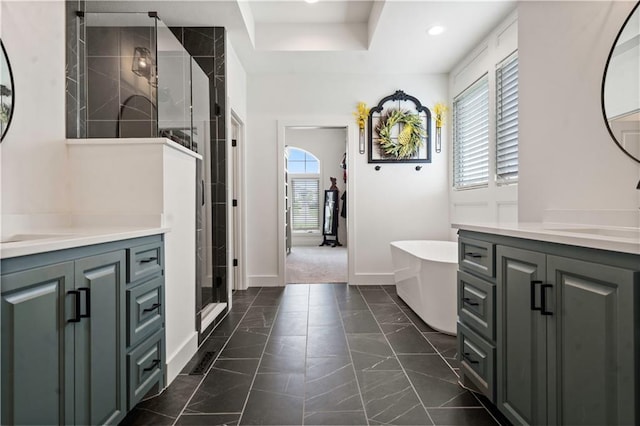 15318 W 172nd Pl, Olathe, KS 66062 - full bathroom with two vanities, a stall shower, a freestanding tub, baseboards, and marble finish floors