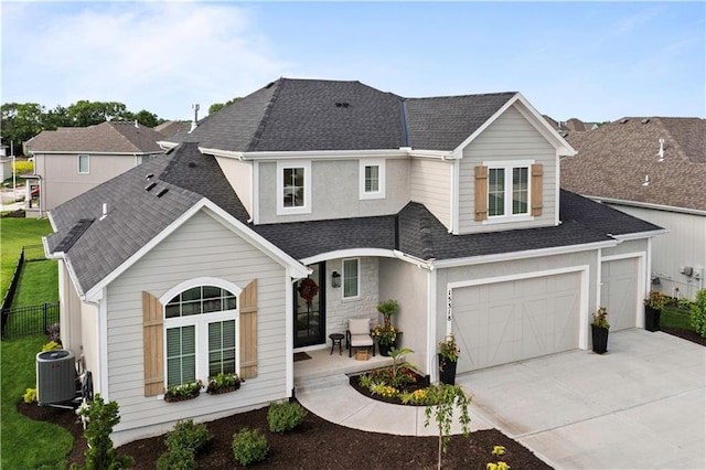 15318 W 172nd Pl, Olathe, KS 66062 - traditional-style home with central air condition unit, a shingled roof, driveway, and an attached garage