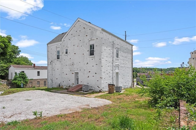 1003 Commercial St, Atchison, KS 66002 - rear view of house with brick siding and central air condition unit