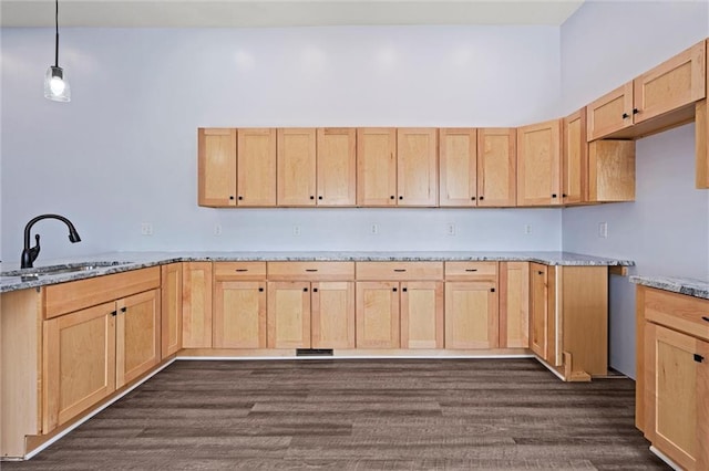 1003 Commercial St, Atchison, KS 66002 - kitchen with light brown cabinetry, a sink, and light stone countertops