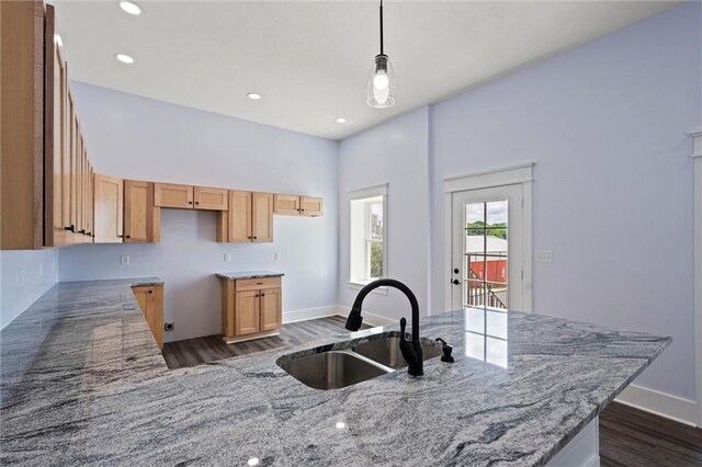 1003 Commercial St, Atchison, KS 66002 - kitchen featuring a sink, dark wood-type flooring, light stone countertops, decorative light fixtures, and recessed lighting