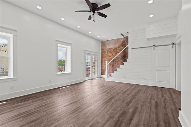 1003 Commercial St, Atchison, KS 66002 - unfurnished living room featuring dark wood finished floors, ceiling fan, baseboards, a barn door, and recessed lighting