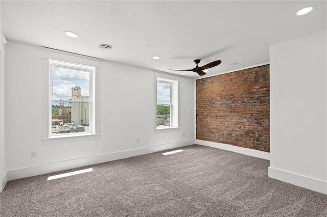 1003 Commercial St, Atchison, KS 66002 - carpeted empty room featuring ceiling fan, baseboards, recessed lighting, and a textured ceiling