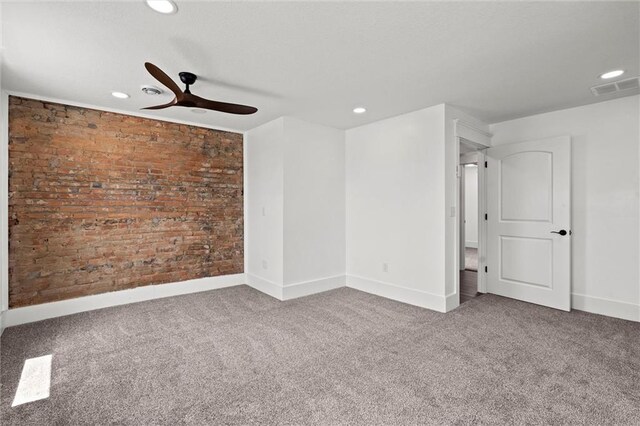 1003 Commercial St, Atchison, KS 66002 - empty room with carpet flooring, ceiling fan, recessed lighting, baseboards, and brick wall